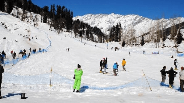 Visitors enjoying skiing and snow activities in Manali